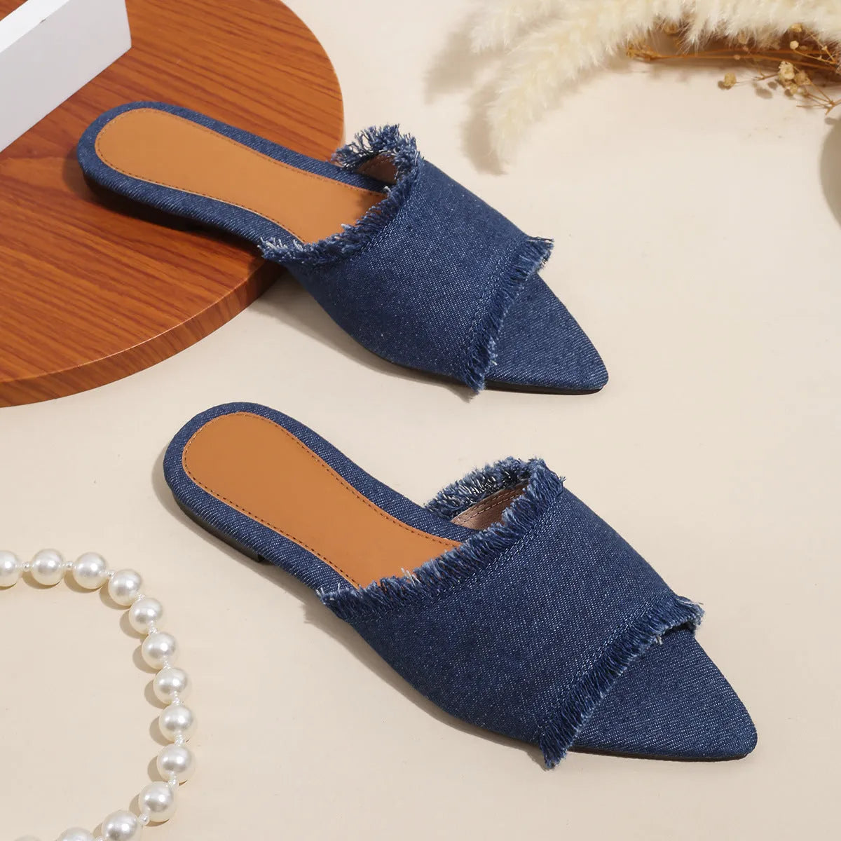 Women's denim flat slippers with tassel detail in multiple colour options showing leather lining and PVC sole