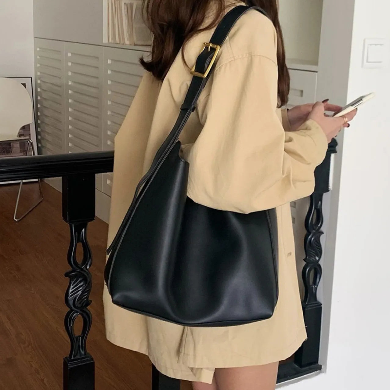 Women's soft PU shoulder bag with swing thread detailing in black ribbon or brown colour options