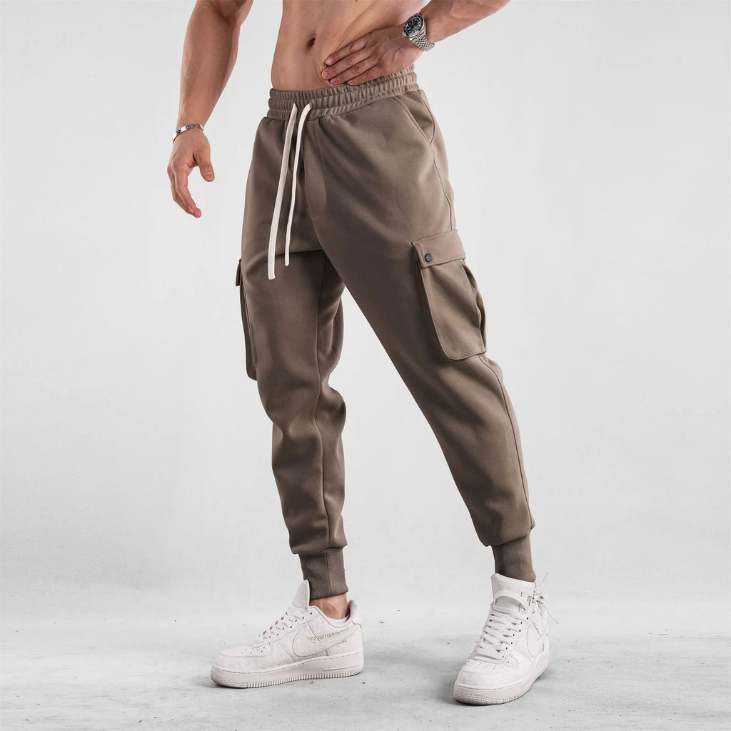 Men's loose light gray cotton trousers with ankle-tied cuffs and multiple pockets