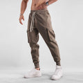 Men's loose light gray cotton trousers with ankle-tied cuffs and multiple pockets