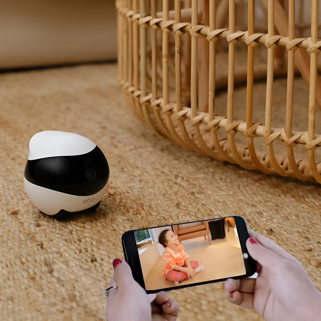 White mobile surveillance robot camera with automatic docking station on wooden floor