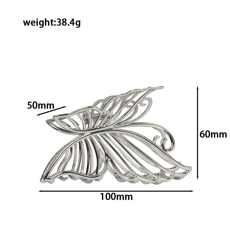 Silver metal hair claw clip assortment showing bows, waves, pearl designs, and geometric shapes from 4cm to 13.5cm