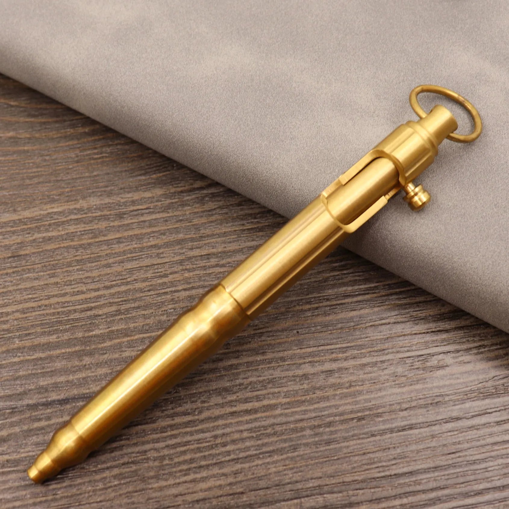 Brass tactical pen with bolt-action mechanism and retro brushed finish