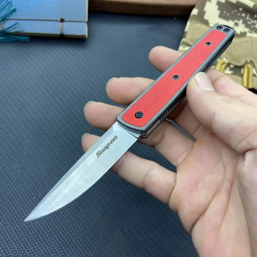 Folding fruit knife with stainless steel blade in black, brown, or red colour options showing closed and open positions