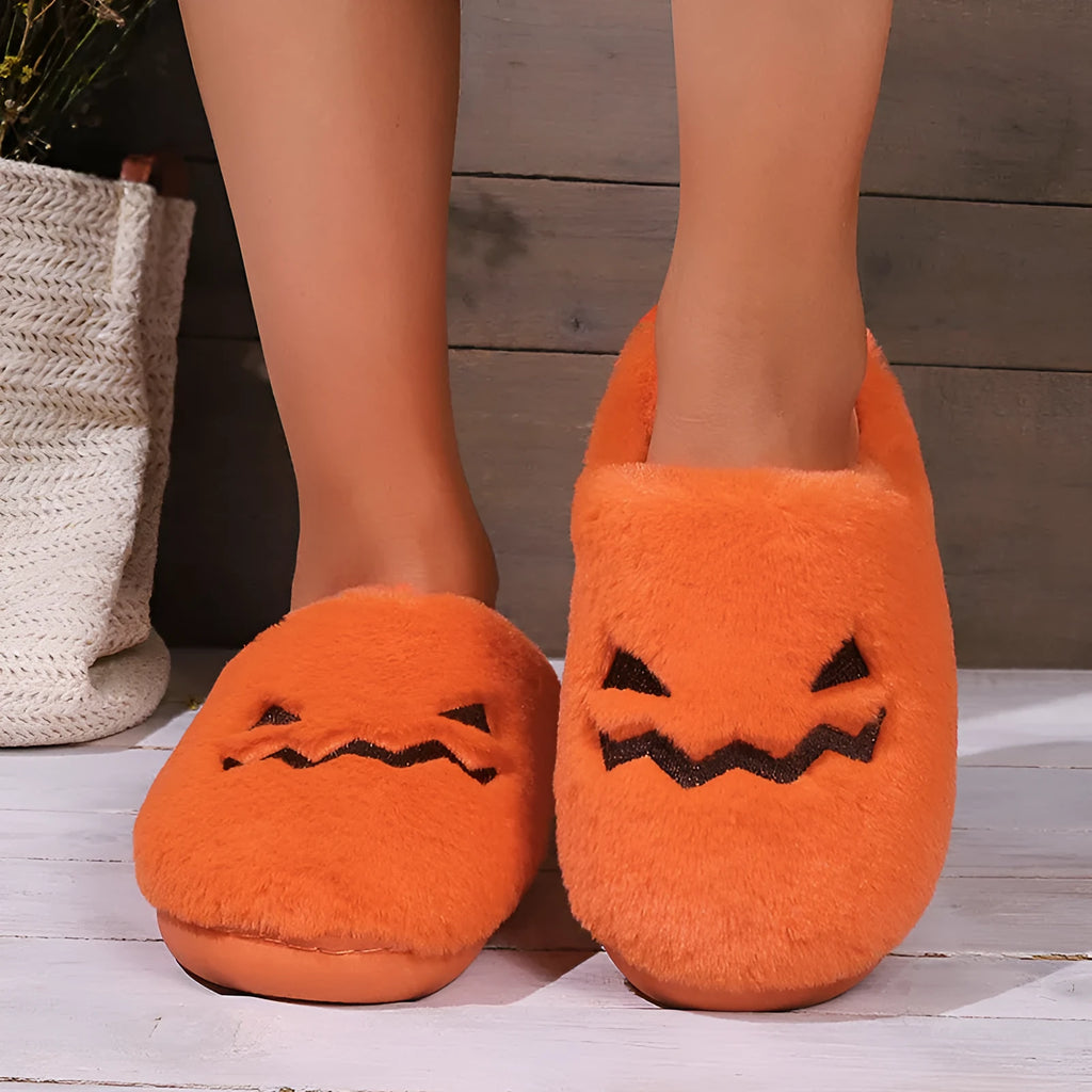 Orange pumpkin-themed plush slippers with a non-slip sole for indoor home wear.