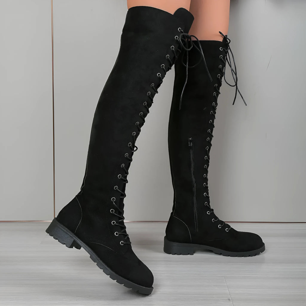 Black lace-up over-the-knee boots with flat heel, round toe and decorative stitching details