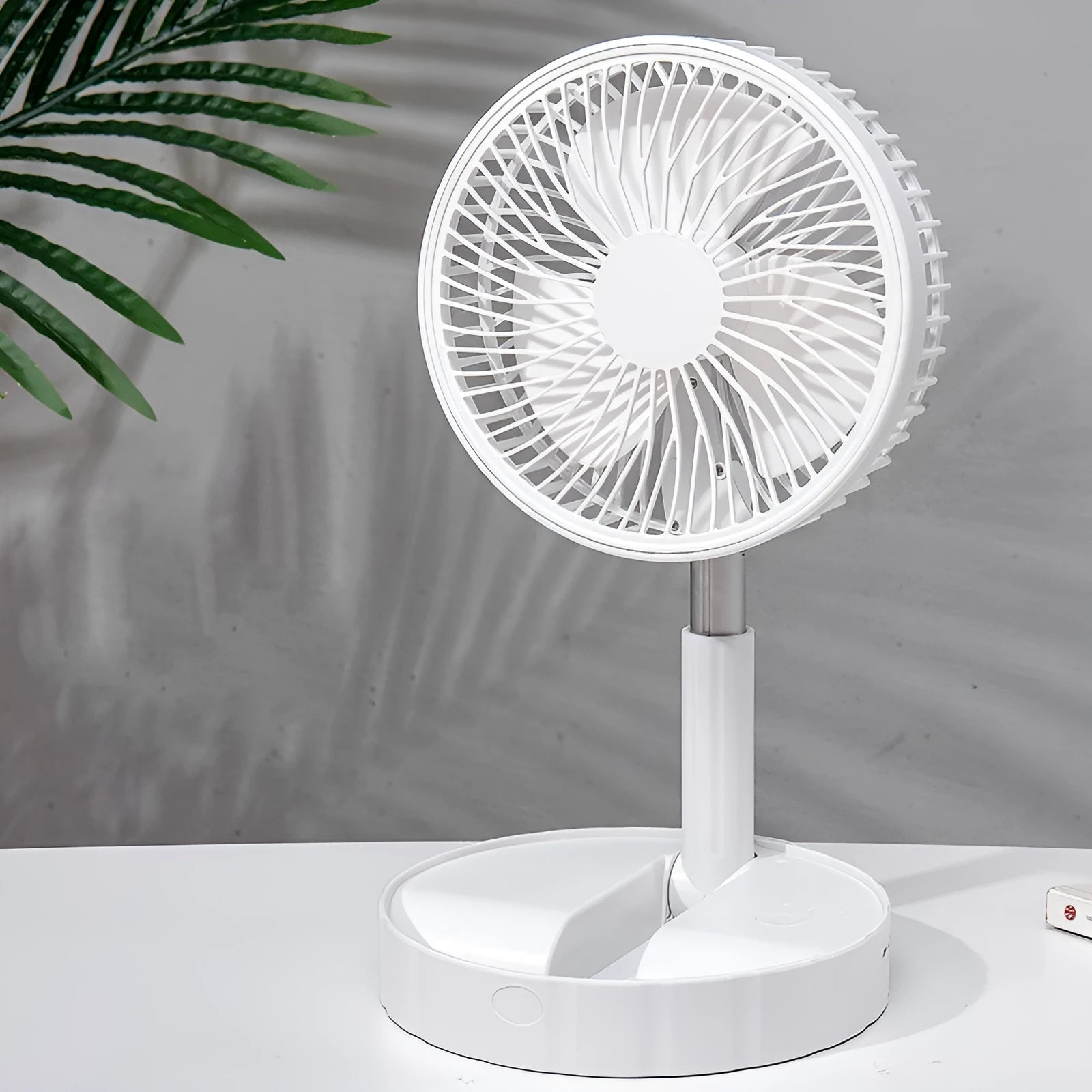 Black portable telescopic folding fan extended to full height showing ABS plastic body and aluminium alloy stand