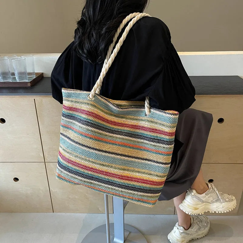 Blue straw woven shoulder bag with single strap showing textured exterior