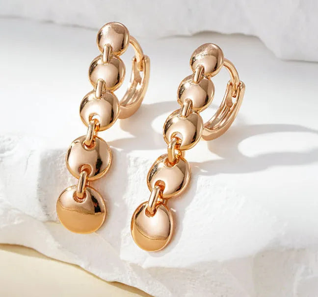 Gold-coloured woven copper round circle drop earrings with retro design.