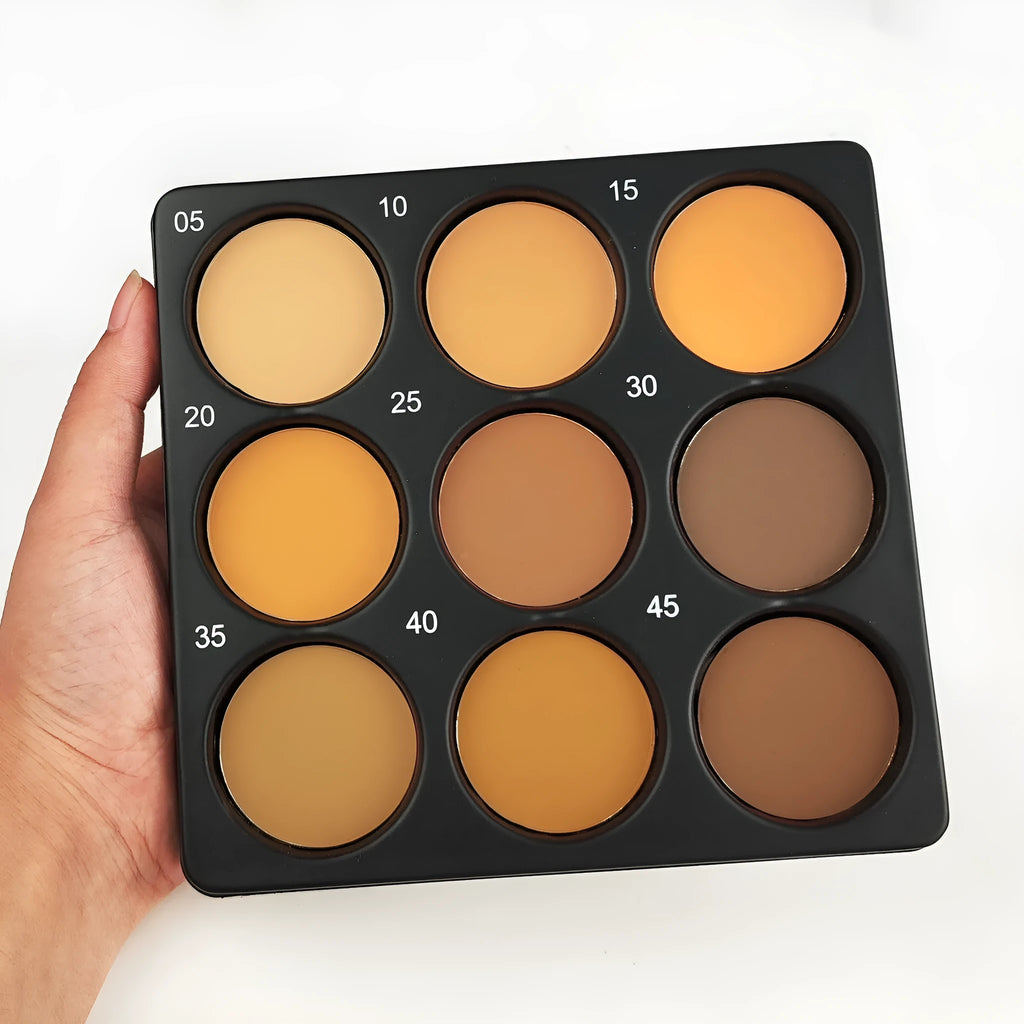 Dark matte makeup palette open showing nine colours with a repair disk
