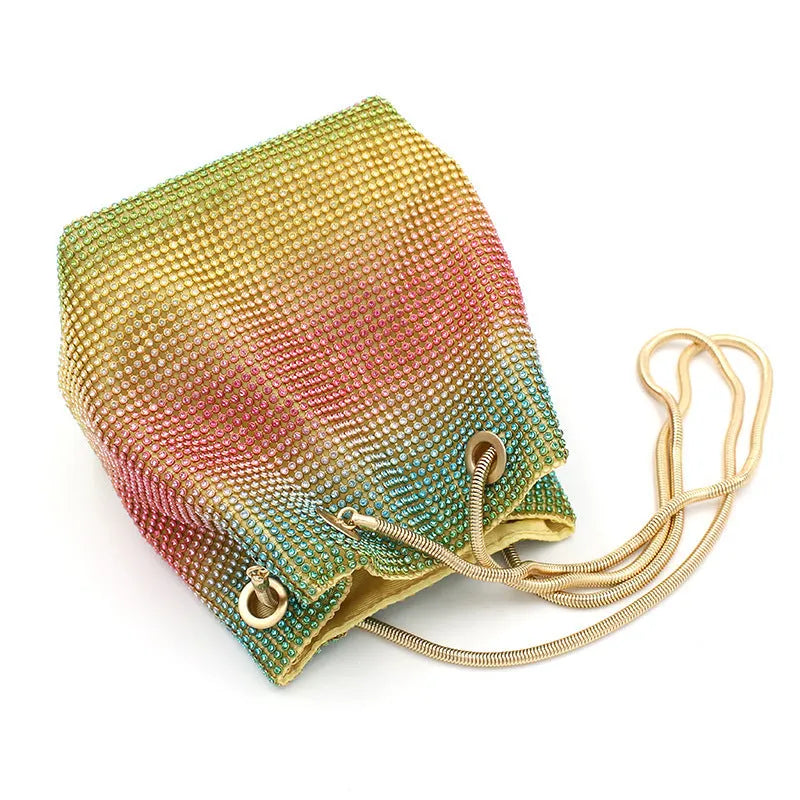Rhinestone-decorated rainbow bucket bag with shoulder strap on a soft fabric base