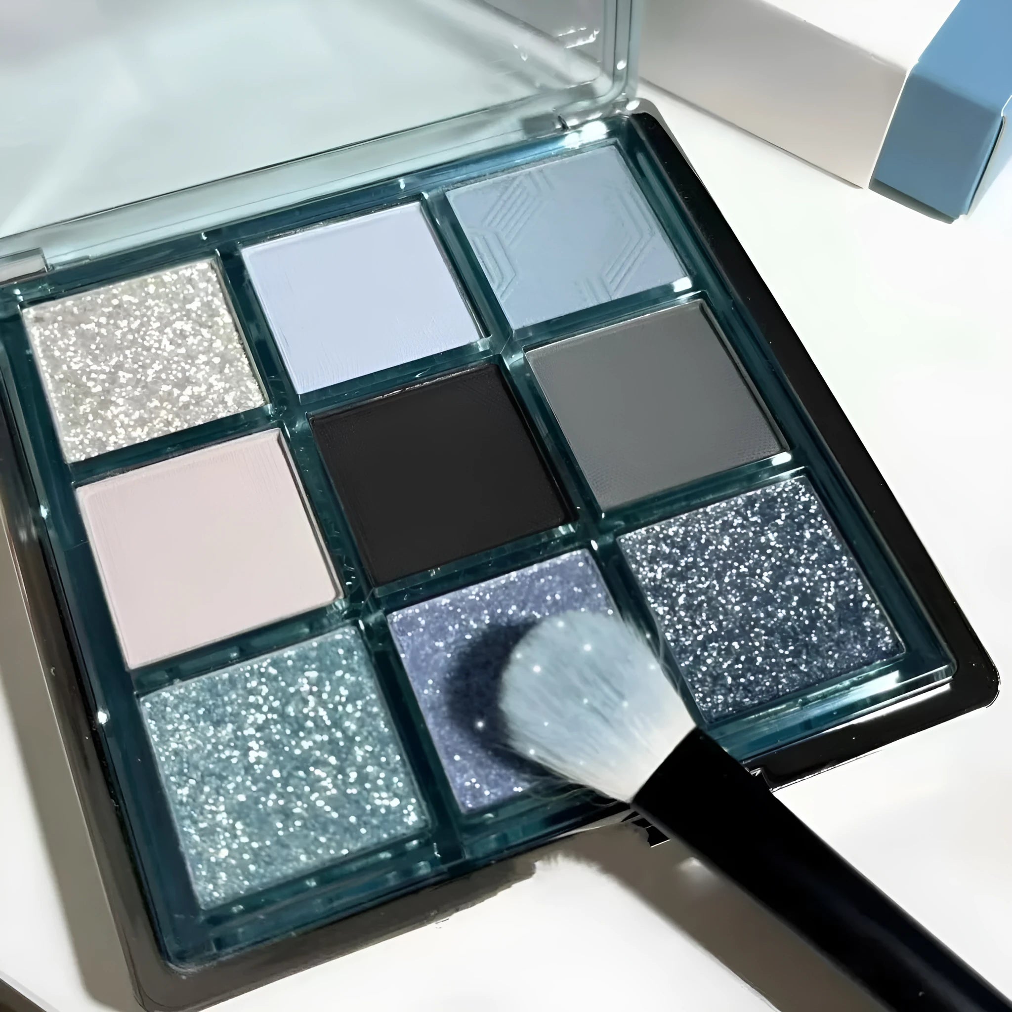 MUGELEEN nine-colour eye shadow palette showing blue smoked and earth tone shades