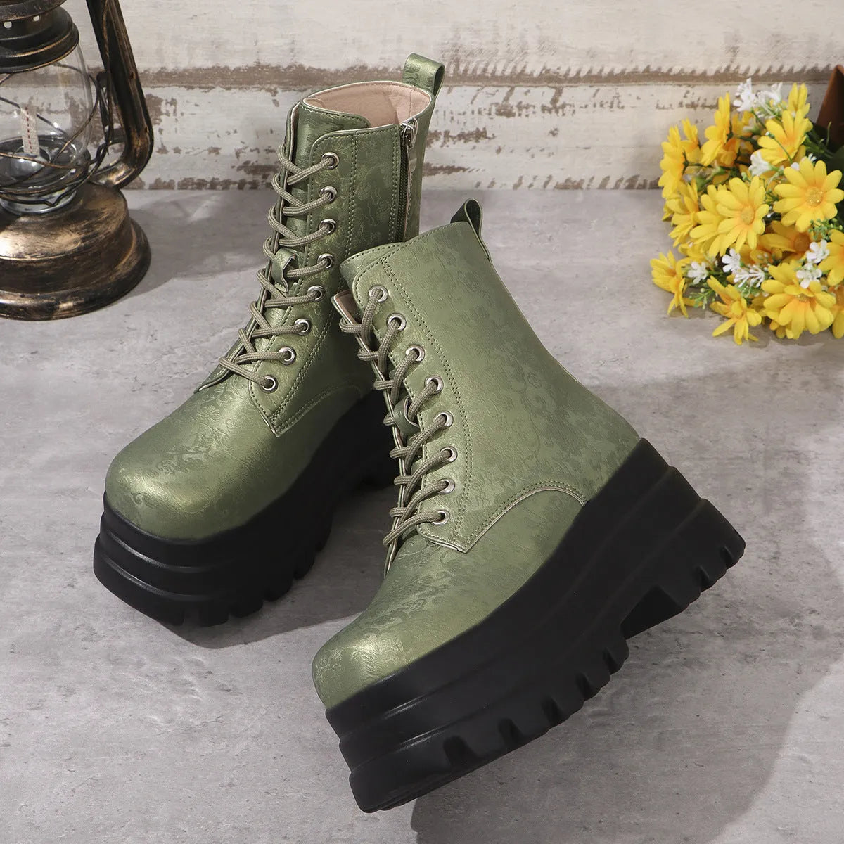 Women's black patchwork platform Martin boots with a chunky heel and side zipper.