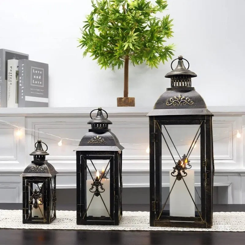 European-style wrought iron floor-standing storm lantern with tempered glass panels in black gold brush finish