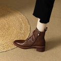 Women's black pointed-toe short ankle boots with a 5.5cm heel on a plain background.