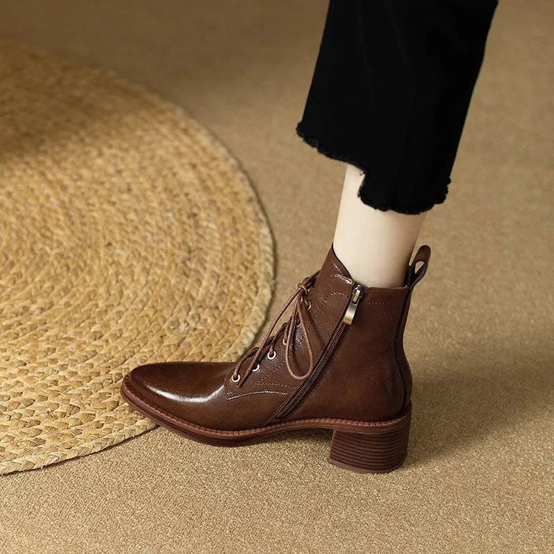 Women's black pointed-toe short ankle boots with a 5.5cm heel on a plain background.