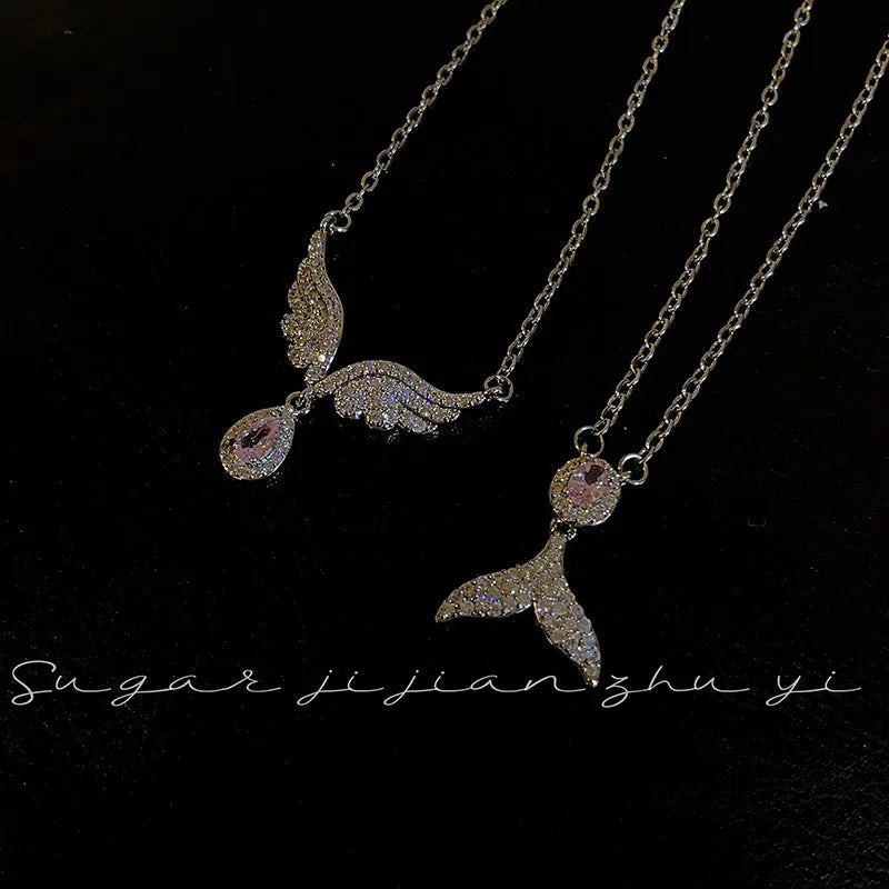 Close-up of a women's sterling silver fishtail pendant necklace on an adjustable O-ring chain.