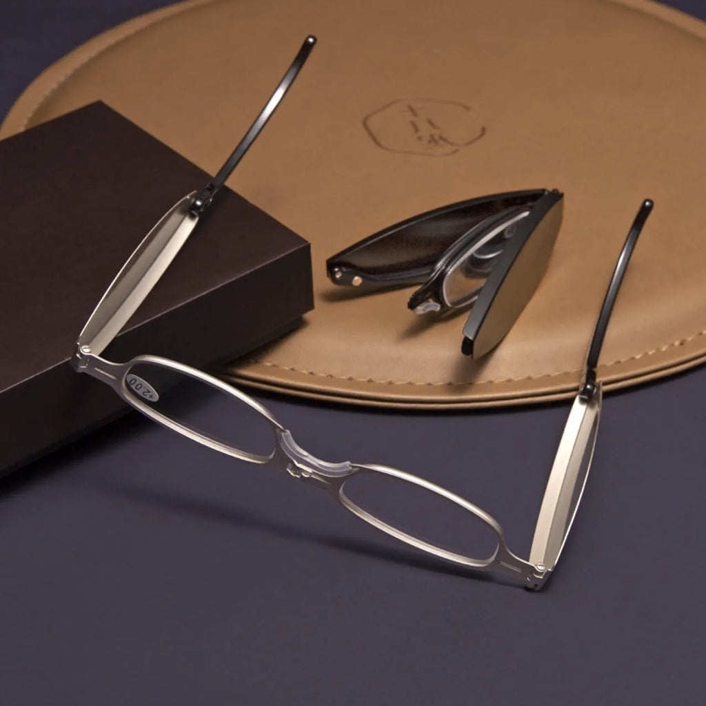 Folding pocket presbyopic glasses in black and silver retro frames with ring detailing