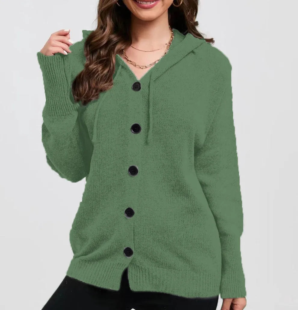 Woman wearing a thick, loose-fit grey hooded cardigan sweater with long sleeves.
