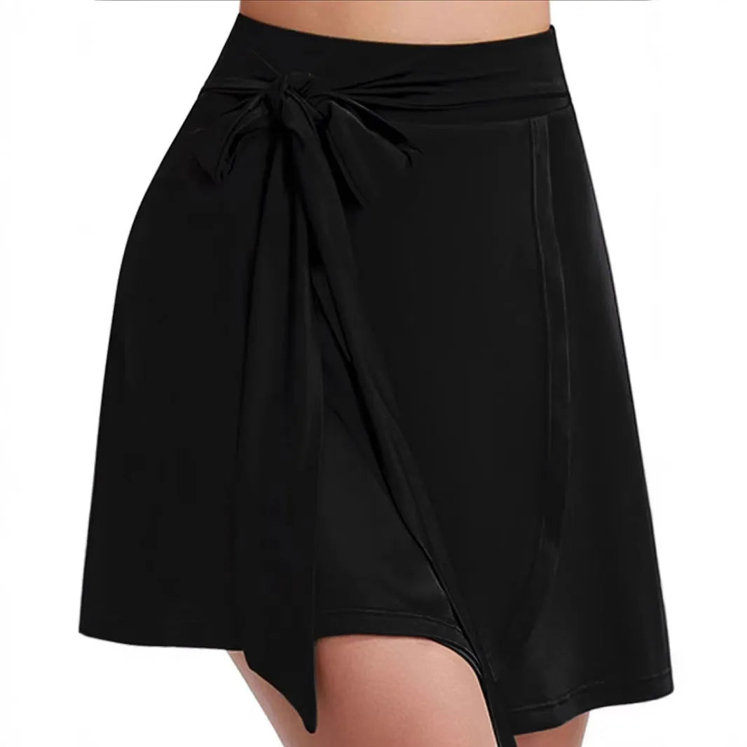 Black thigh-length sports skirt with built-in shorts, high waist, and culotte style.