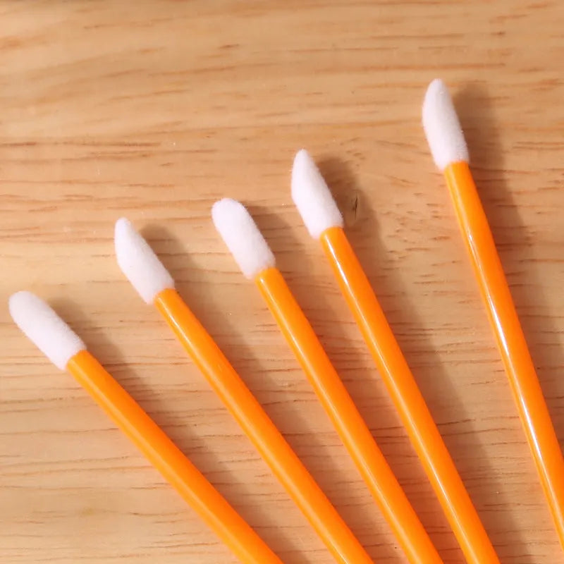 Disposable lip brushes with flocked heads and black handles in various colours