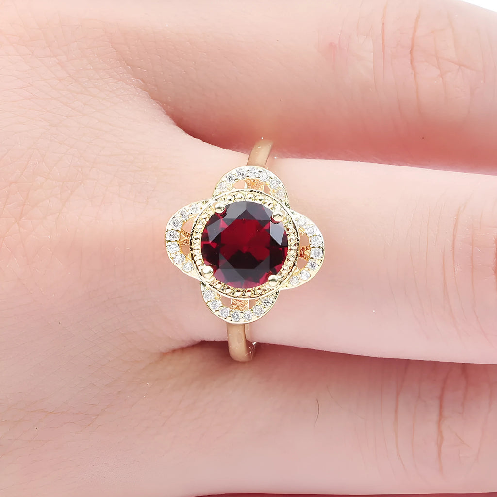 Copper fruit-shaped ring with electroplated zircon detailing on a hand.