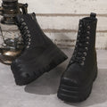 Women's black patchwork platform Martin boots with a chunky heel and side zipper.