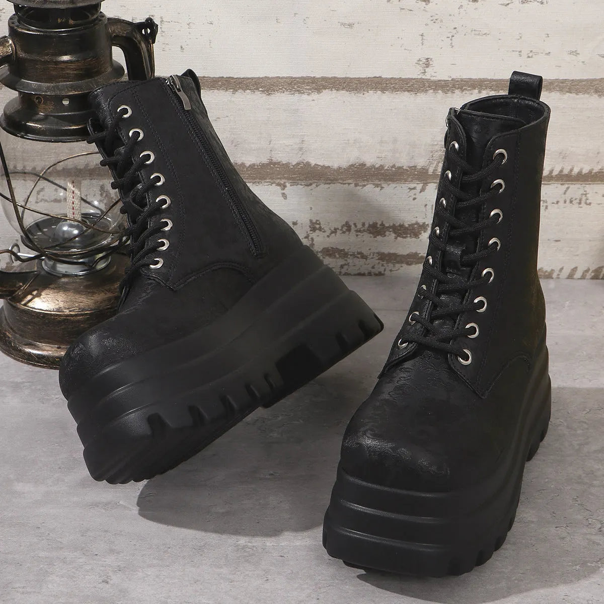 Women's black patchwork platform Martin boots with a chunky heel and side zipper.