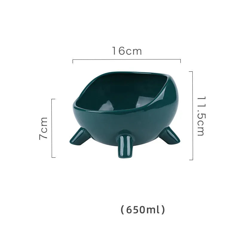 Green ceramic cat food bowl with four legs and rounded arc design on wooden floor