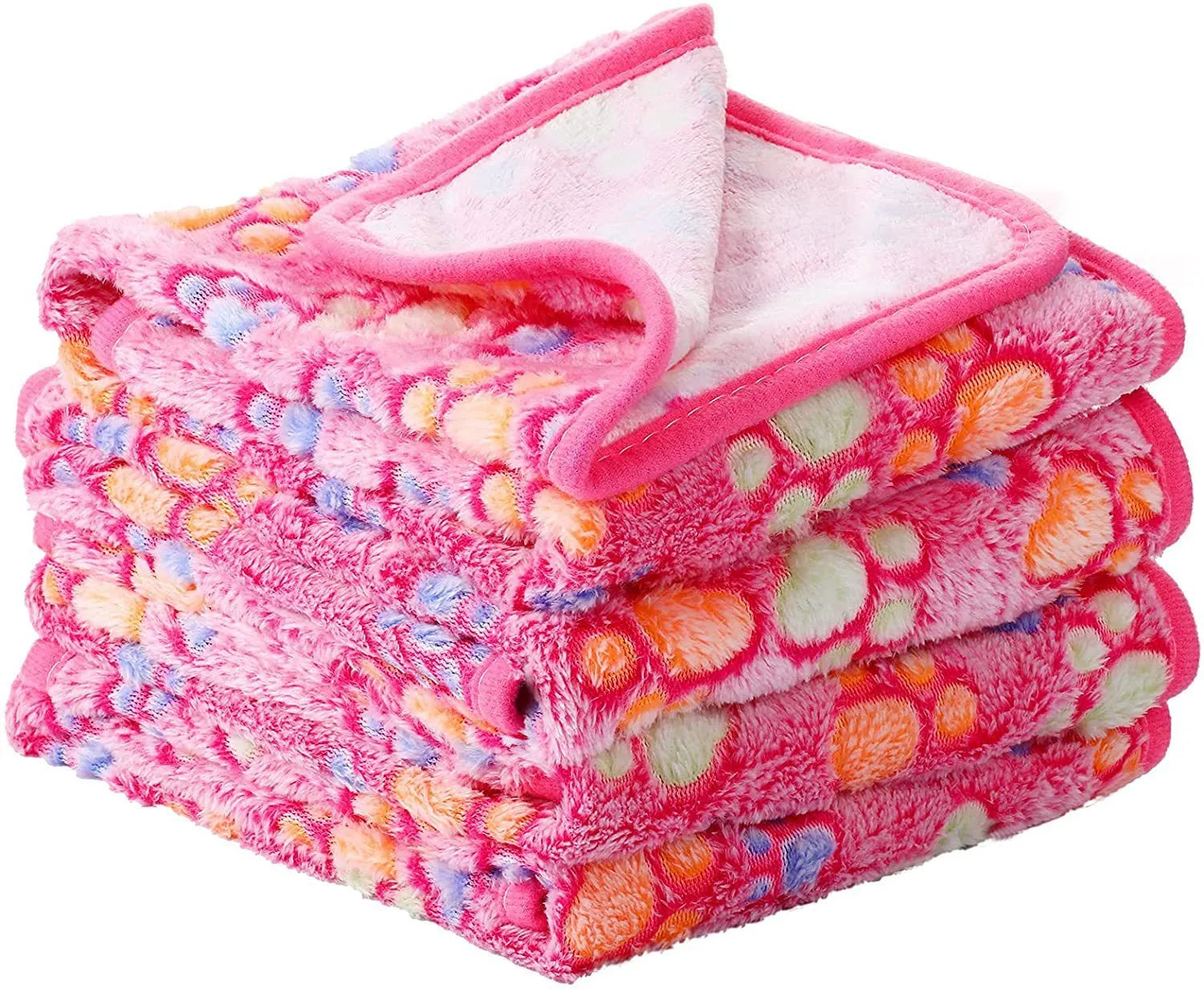 Coral fleece pet blanket with dog's paw print pattern in beige, shown in a large size on a dog bed.