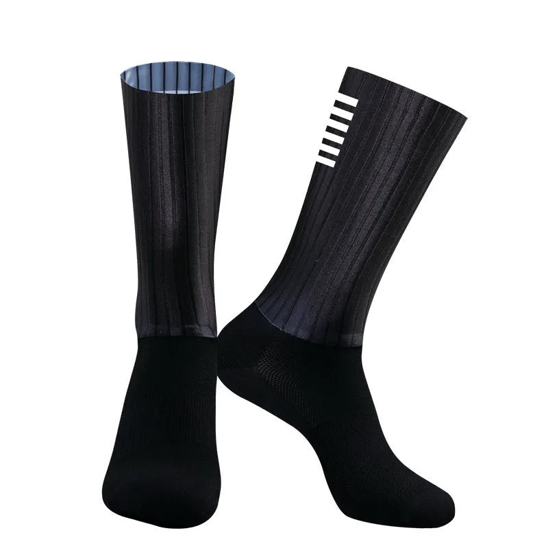 Pair of breathable athletic socks for running and cycling in orange colour on a grey background