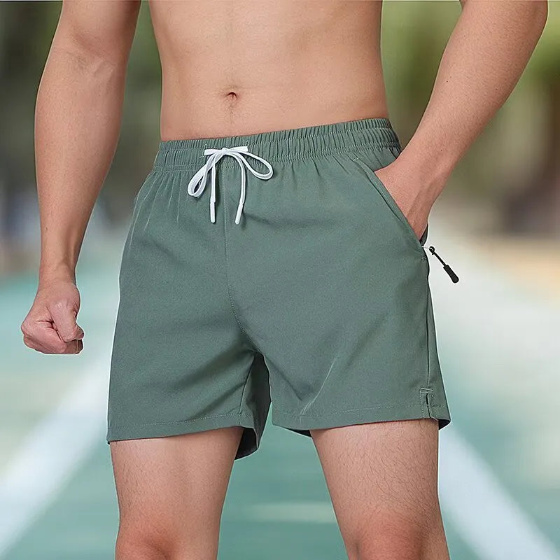 Black men's polyester fitness training shorts with a high waist and drawstring closure.