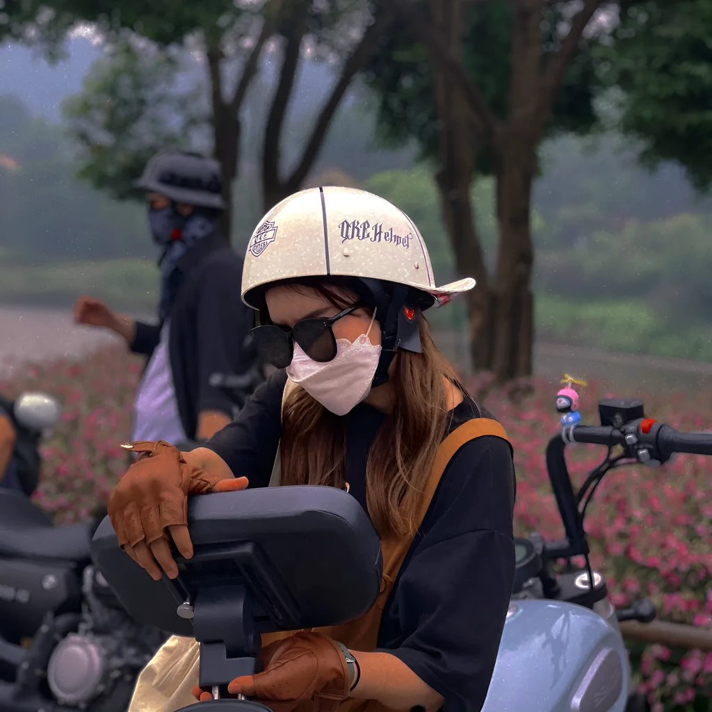 Retro-style half helmet for electric bicycles in bright black with a gradient blue tinted lens.