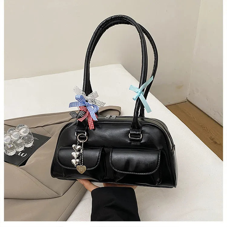 Retro pillow-shaped leather women's handbag with one shoulder underarm design in black with ribbon pendant