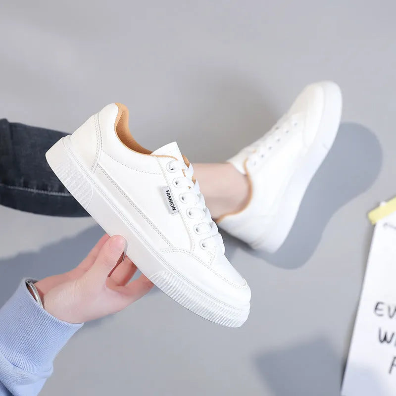 Women's low-top Korean style sneaker in white or brown artificial PU leather with a plastic sole.
