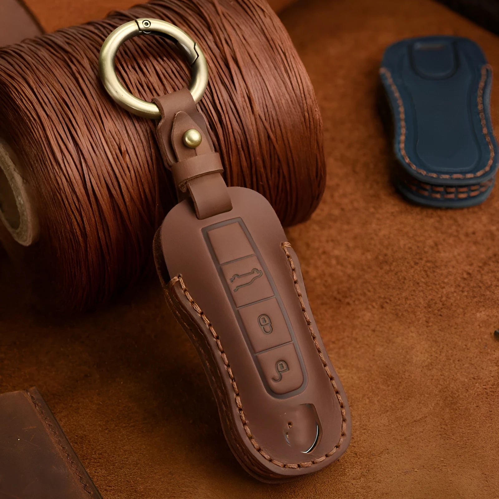 Authentic brown cowhide leather Porsche key case with a retro metal buckle closure.