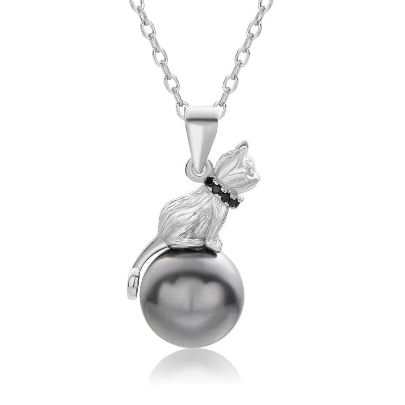 Close-up of a sterling silver cat silhouette pendant on a clavicle-length chain.