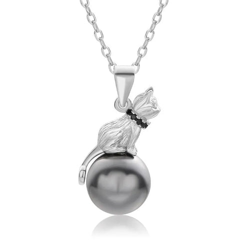 Close-up of a sterling silver cat silhouette pendant on a clavicle-length chain.