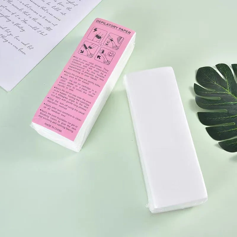 A pack of soft, white non-woven fabric hair removal wax paper strips.