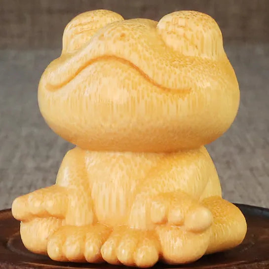 Solid bamboo smiling frog carving ornament measuring 5cm tall with cartoon design