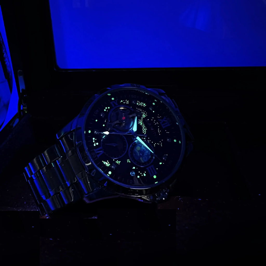 Men's rose gold automatic watch with large black dial on wrist.
