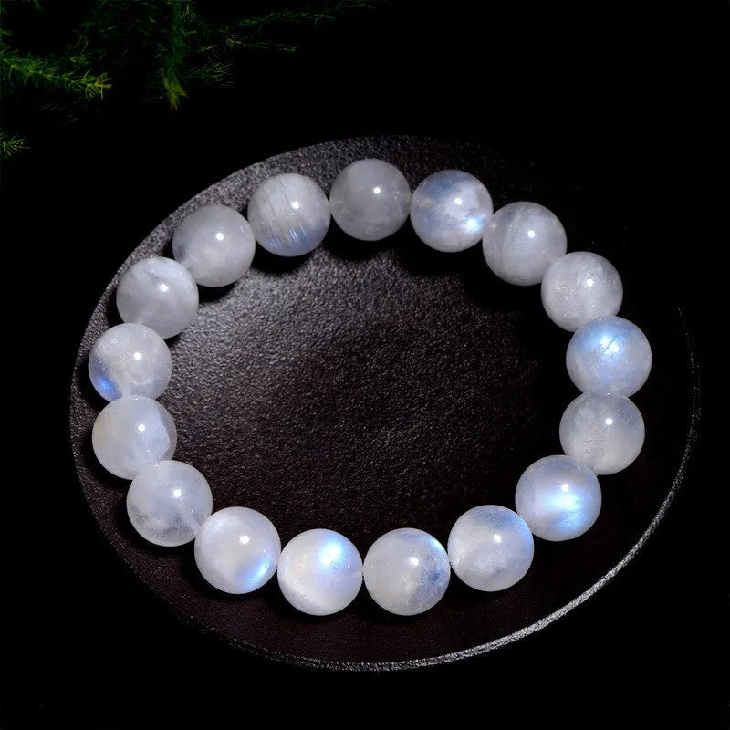 Natural blue moonlight moonstone round bead bracelet showing polished geometric beads on wrist