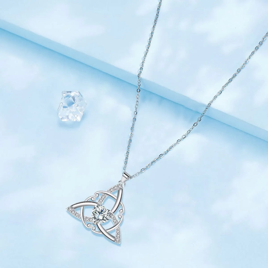 Close-up of a women's Celtic knot pendant necklace with geometric design in a choice of blue, lvzuan, red diamond or white diamond colour.
