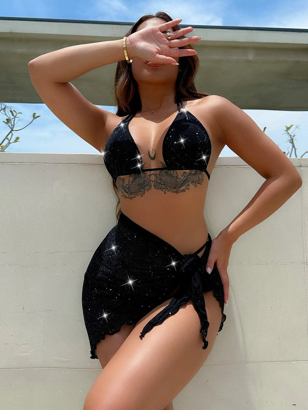 Black three-piece bikini swimsuit set showing separate top and shorts on mannequin