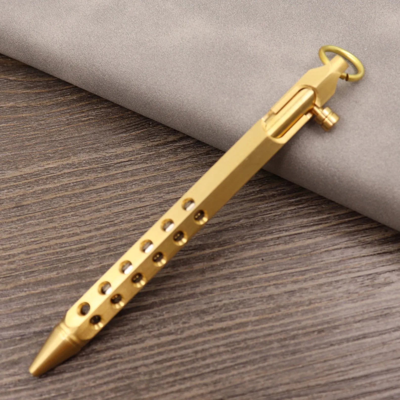 Brass tactical pen with bolt-action mechanism and retro brushed finish