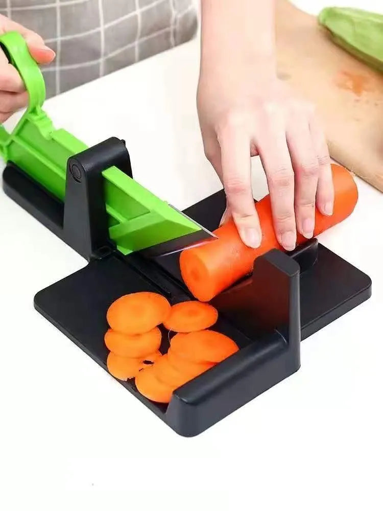 Green and red modern vegetable cutting tool for carrots and potatoes on a kitchen counter