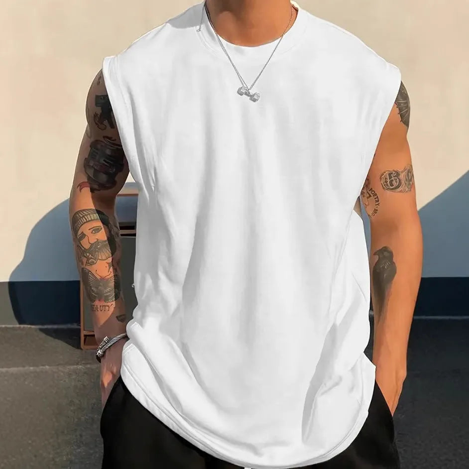 Men's loose cotton tank top in dark grey showing straight hem design and sleeveless construction