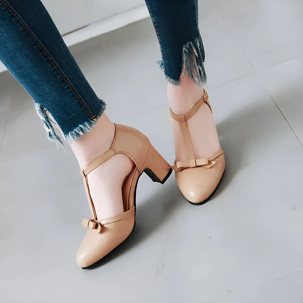 Yellow women's sandals with a chunky 6.5cm heel, bow tie detail, and buckle strap on a round toe.