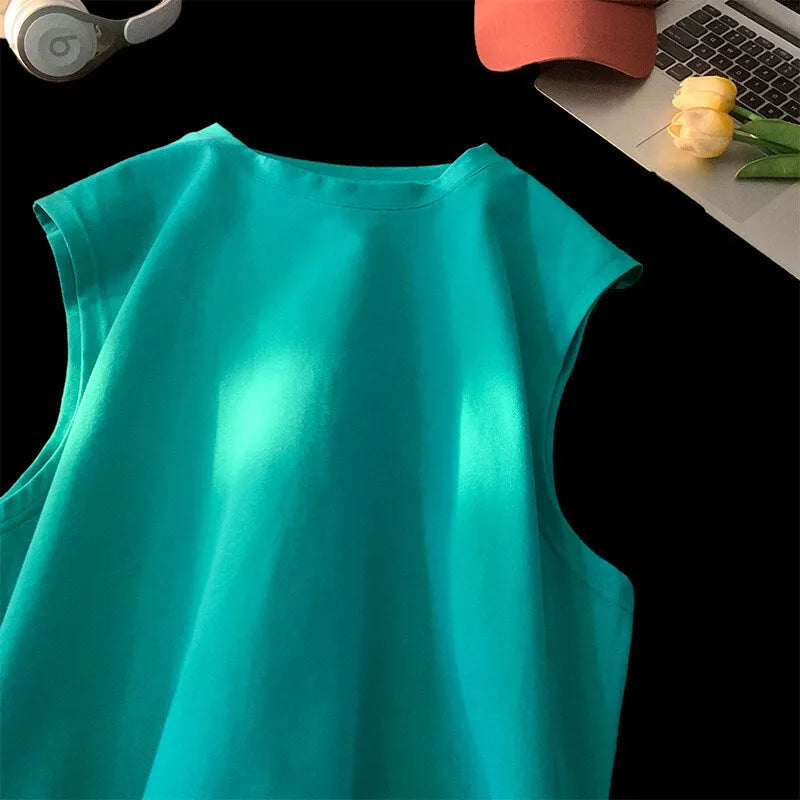 Men's loose cotton tank top in dark grey showing straight hem design and sleeveless construction