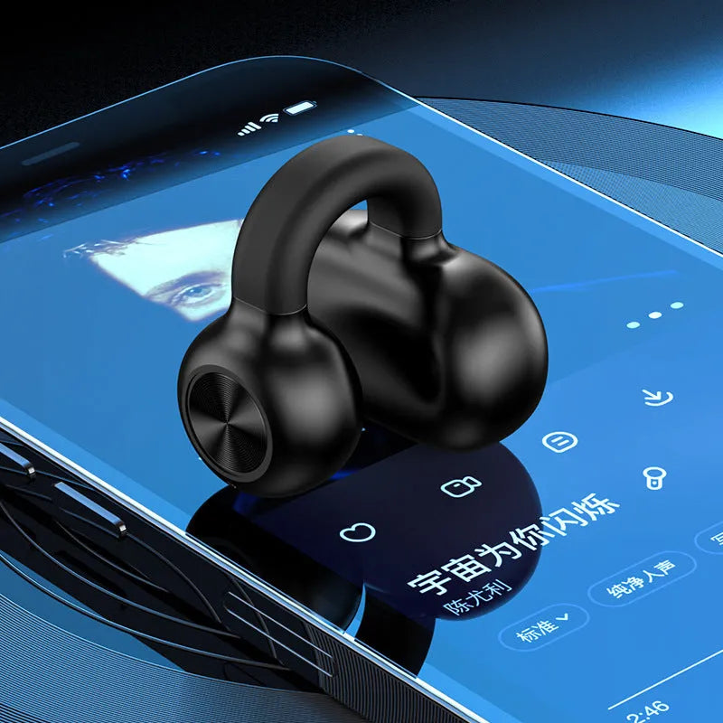 Black wireless Bluetooth clip-on earphones with bone conduction technology displayed beside charging cable